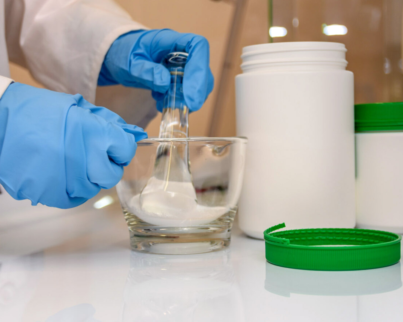 Pharmacist compounding medication in the Greenhill lab